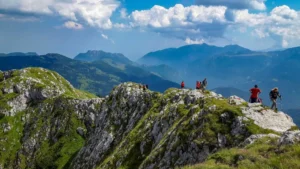 Hikers walking along a rocky mountain ridge in the Balkan Mountains with panoramic valley views