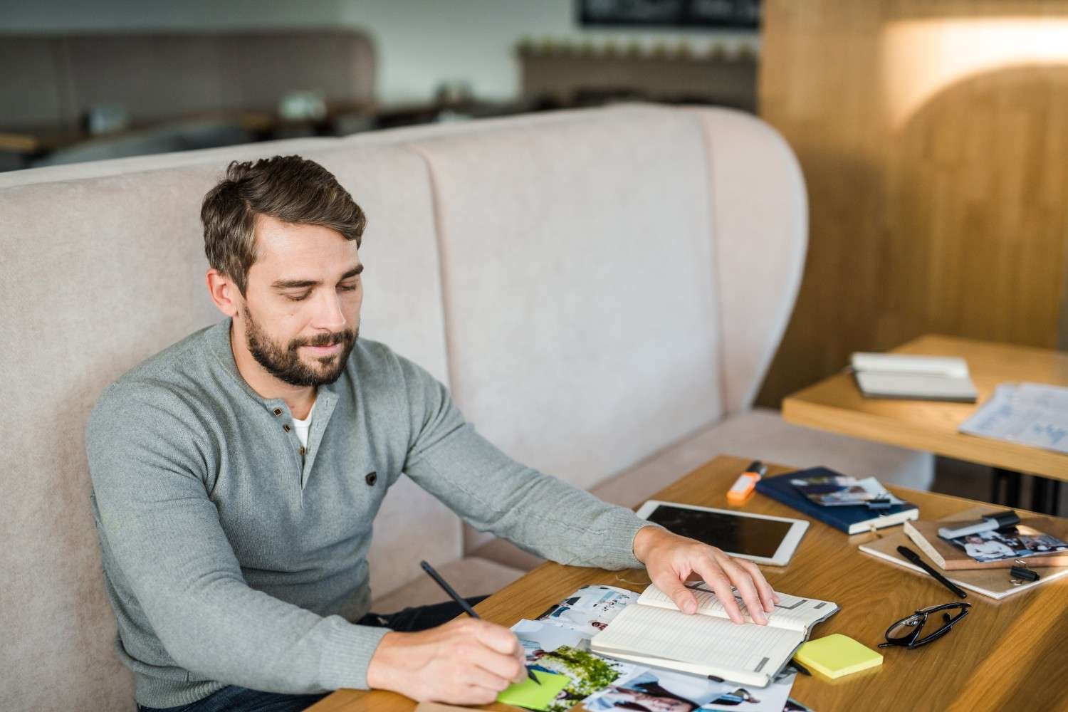 Person organizing finances and writing smart finance tips in a notebook