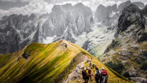 Hikers walking through the stunning Grbaja Valley in Prokletije National Park, Montenegro.