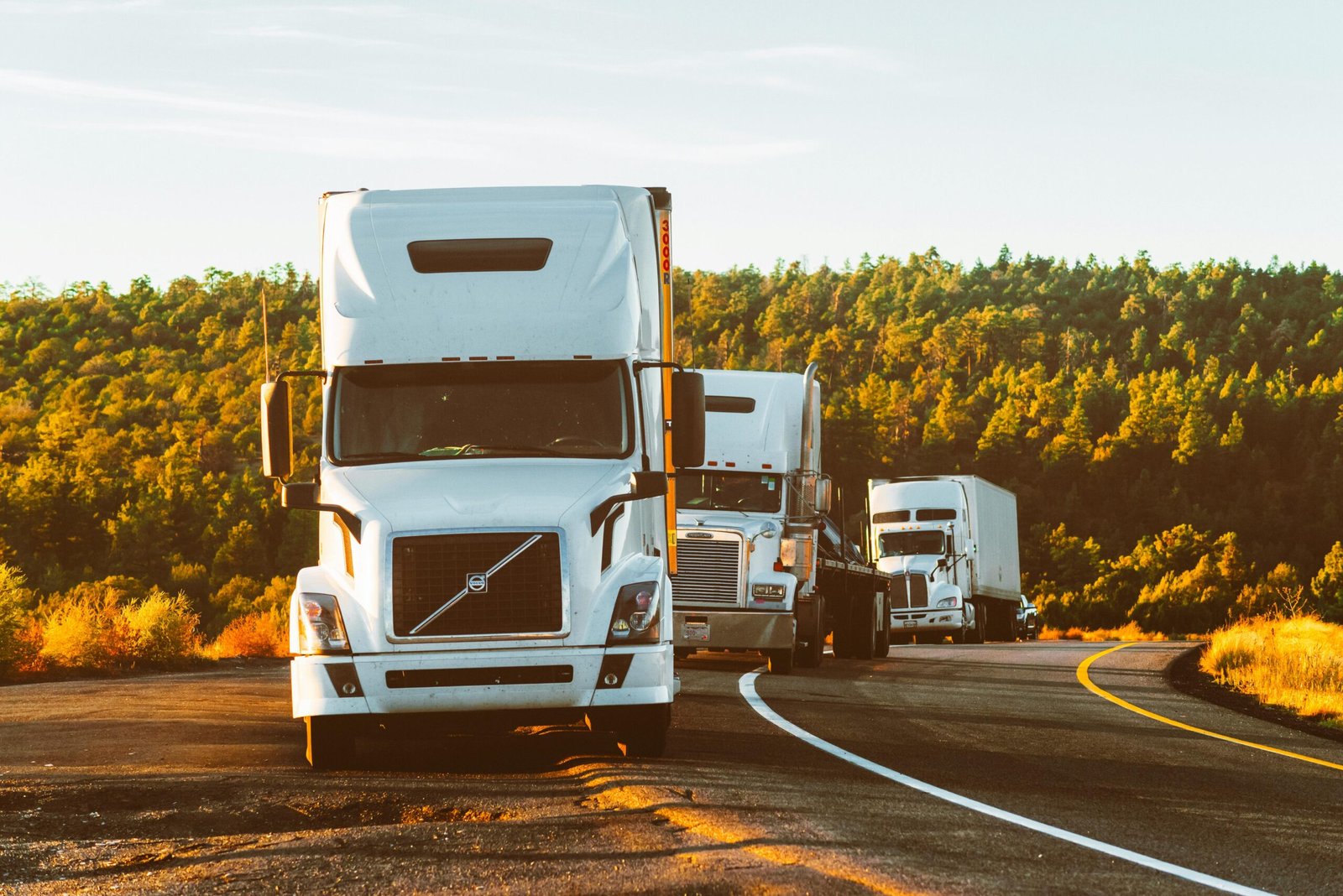 Commercial truck driving on a California highway representing affordable CA Truck Insurance options for owner-operators.