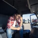 truck-driver-sitting-his-truck-cabin-feeling-worried-upset-min